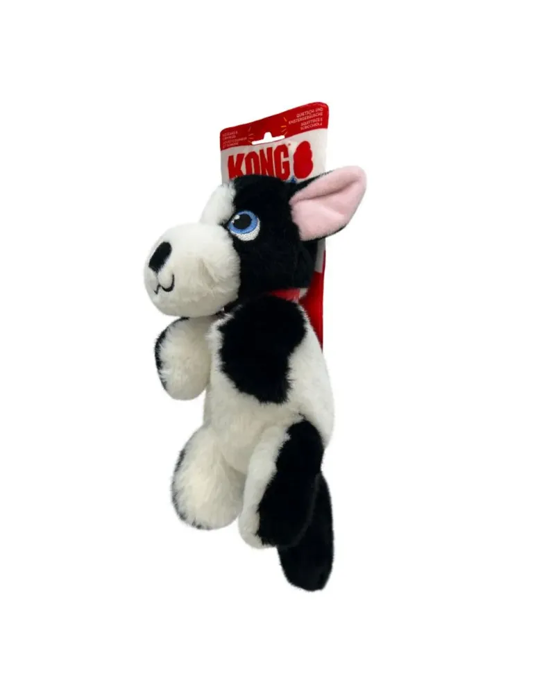Vista lateral del peluche KONG Comfort Tykes Perro blanco y negro, con etiqueta roja, felpa suave y diseño tierno de perfil.